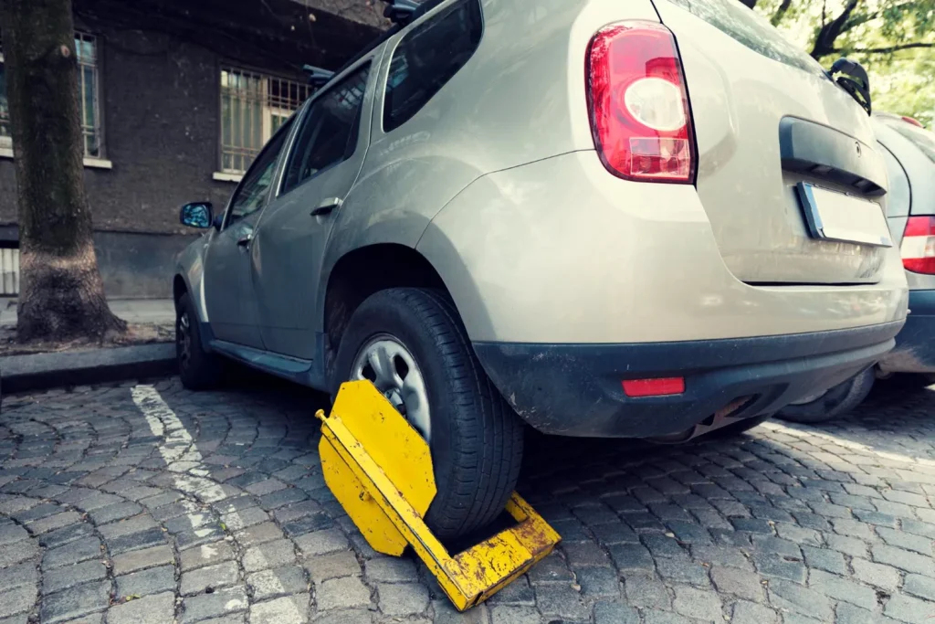 clamped car in a parking space on a road