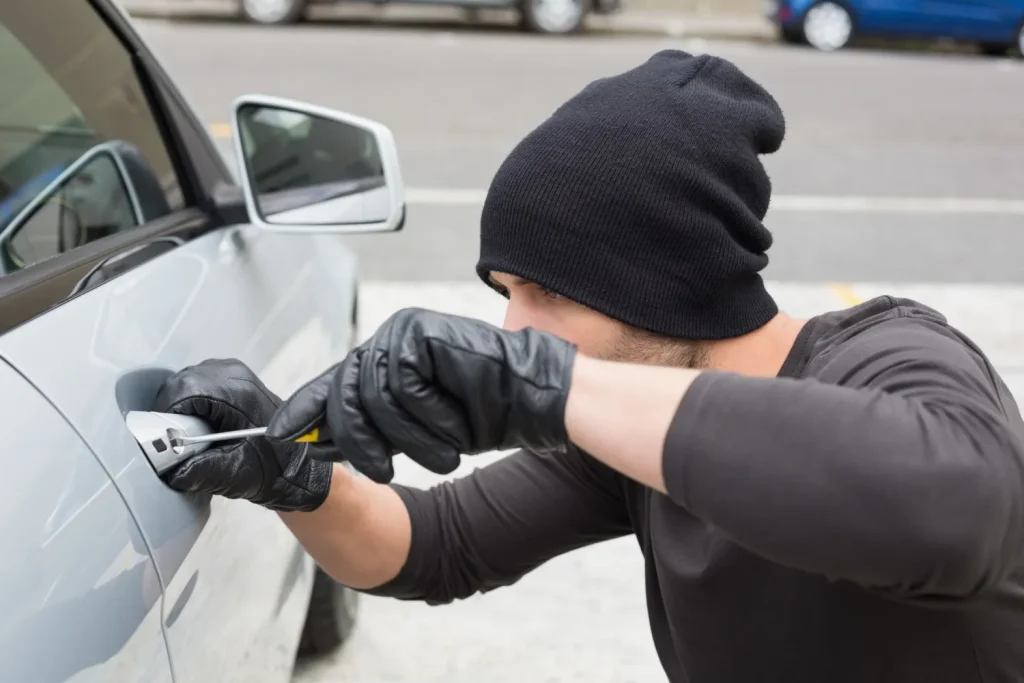 man breaking into a car