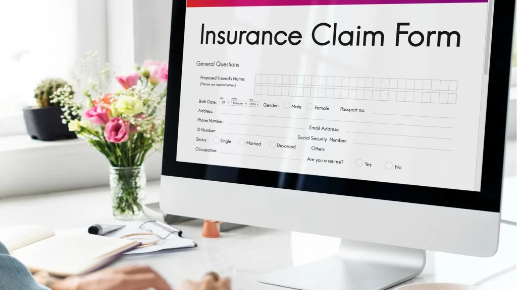 person filling in an insurance claim form online
