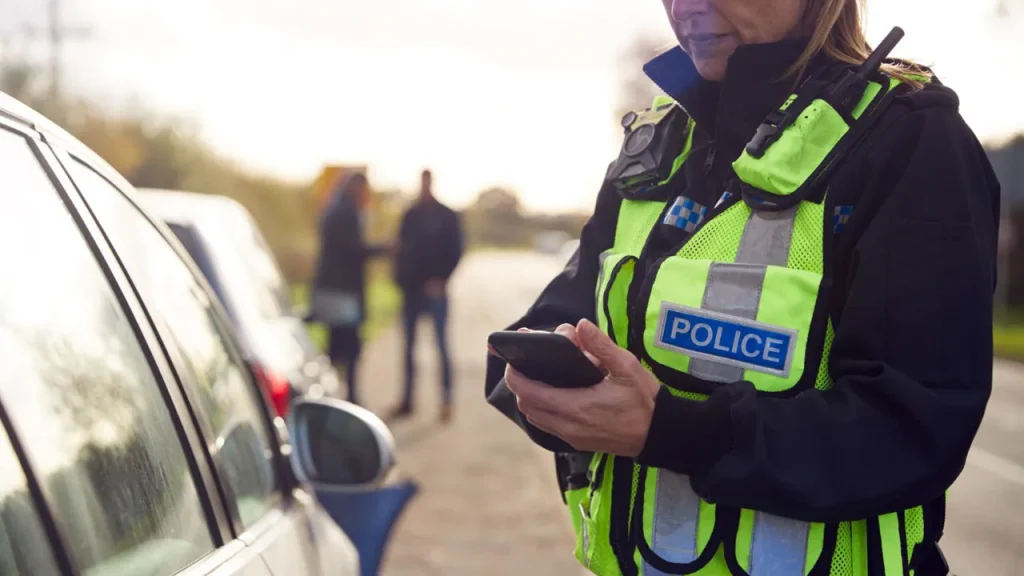 policeman handing someone a ticket