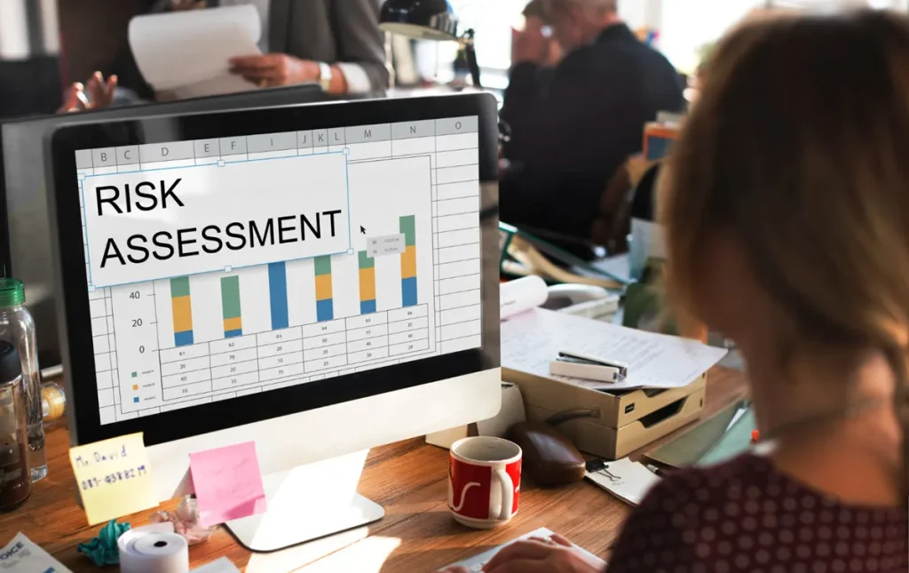 woman looking at risk assessment spreadsheet on computer